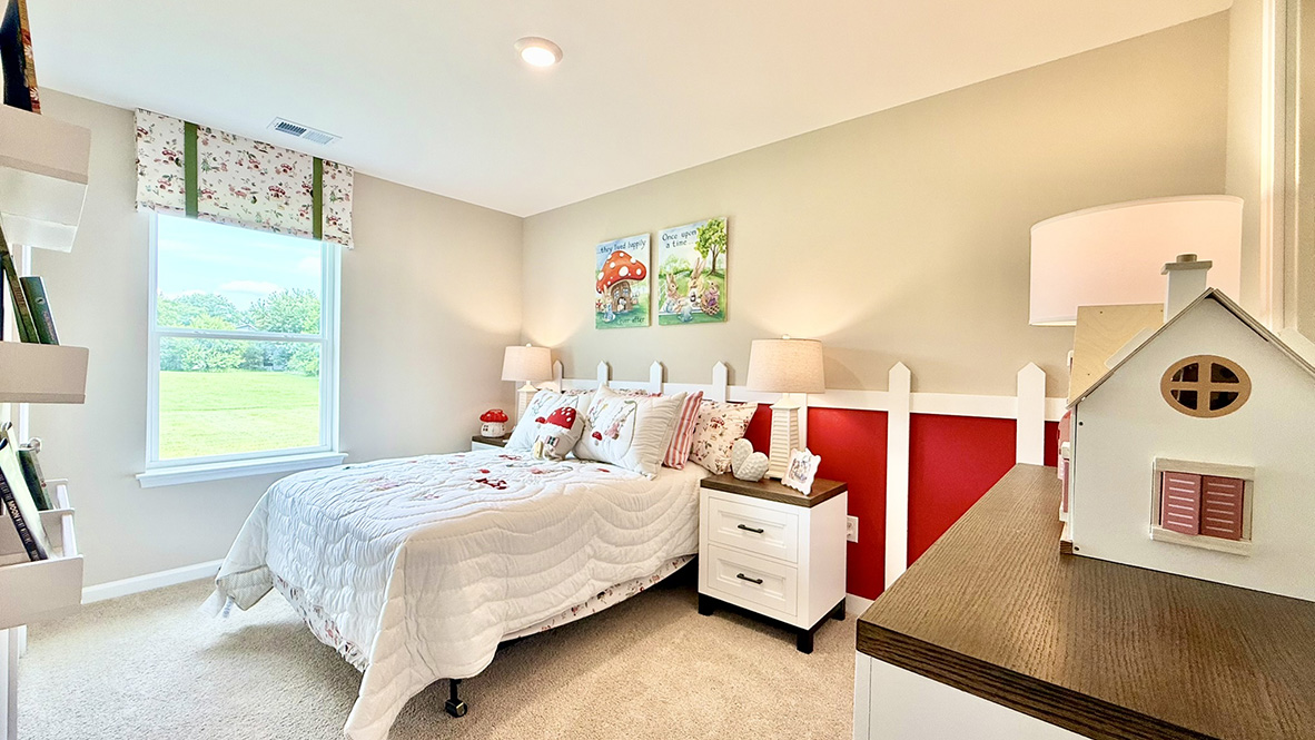 Just off the foyer, two spacious guest bedrooms and a shared full bathroom offer comfort and privacy for family or visitors.