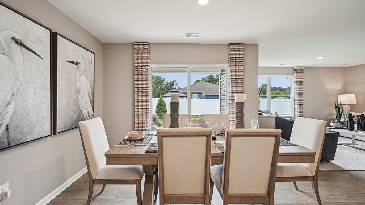 Laminate plank flooring continues through the dining area.
