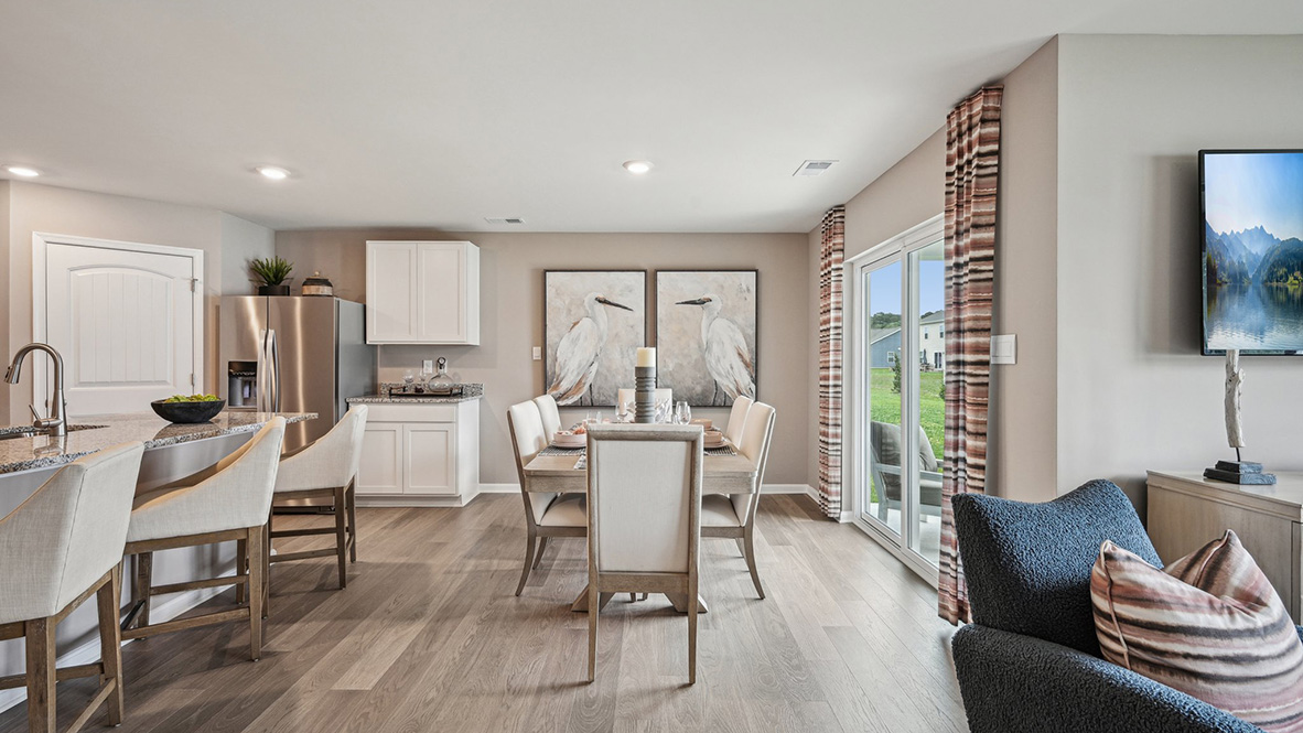 The kitchen is open to the informal dining area that leads to the back sliding door.