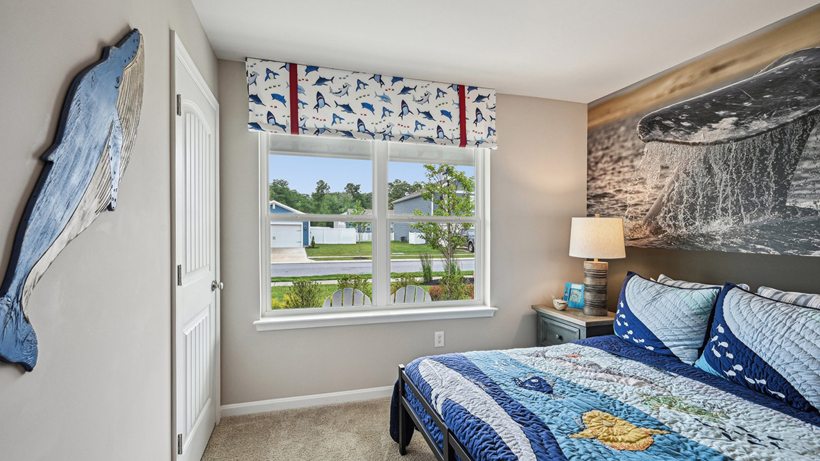 One second guest bedroom has a closet in the corner of the room.