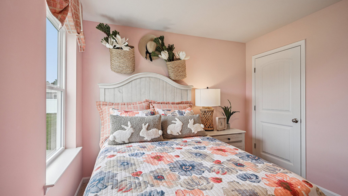 One second guest bedroom has a closet in the corner of the room.