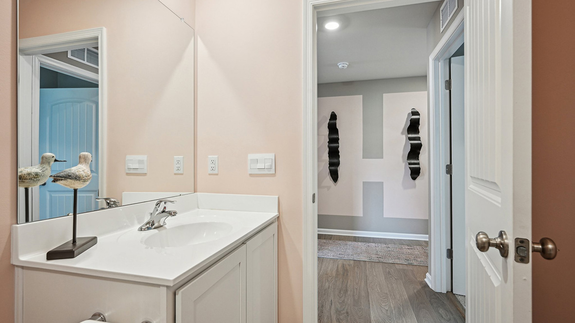 Two guest bedrooms share the same bath.