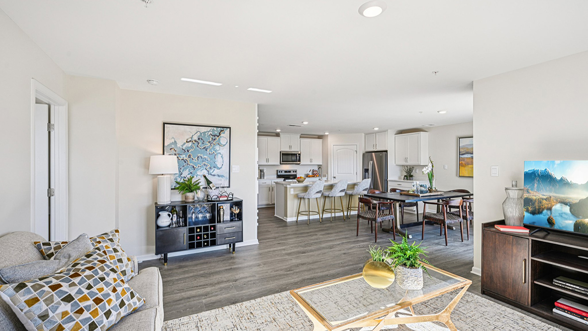 The cozy living area has a double window and laminate plank flooring.