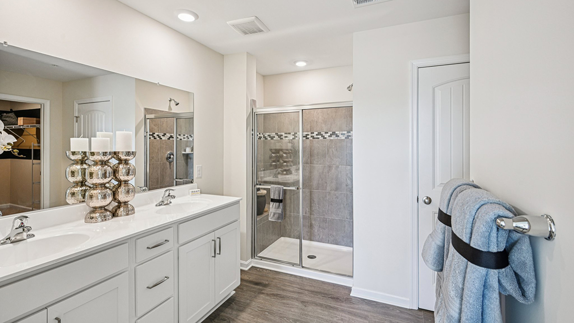 The guest bathroom includes a vanity, toilet, and shower tub.