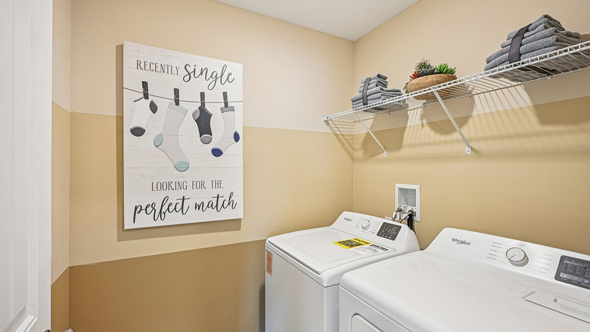 The laundry room comes complete with a washer and dryer.