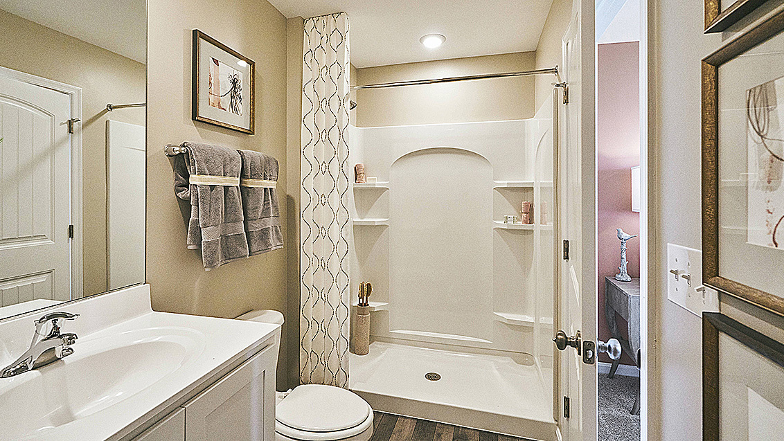 The owner's suite is privately tucked away from the great room and features a walk-in closet and a private, full bathroom.