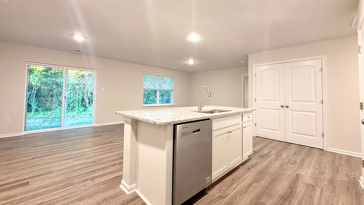 The oversized great room with an abundance of natural light is open to the dining area.