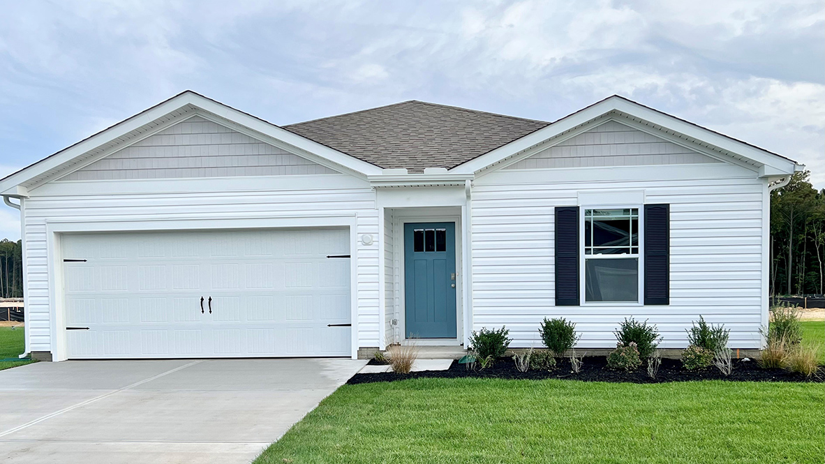 Birdsong Village Freeport ranch home with white siding and a light blue front door.