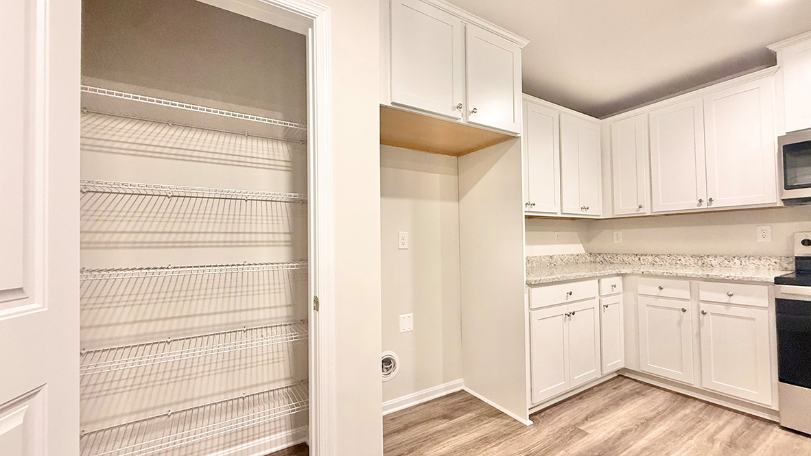The functional kitchen offers a pantry closet.