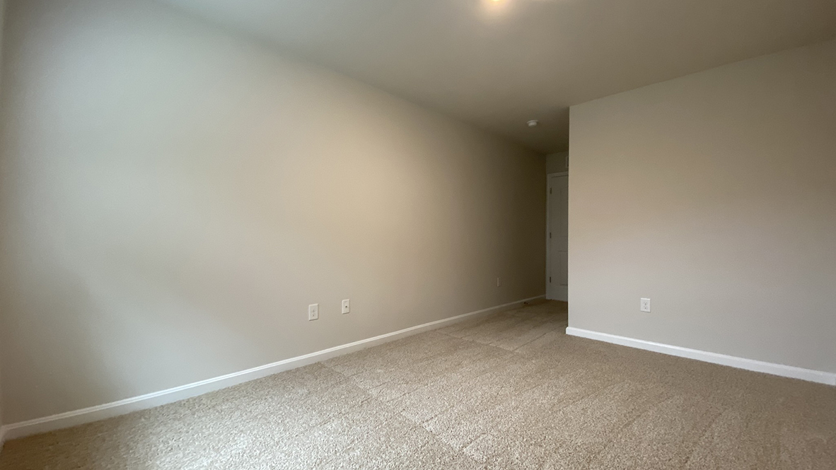 A spacious guest bedroom with a closet is in the front of the home.