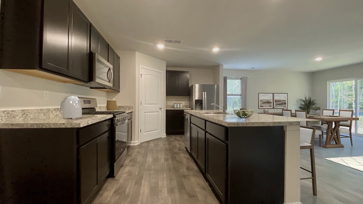 The home's well-designed kitchen features tasteful cabinetry.