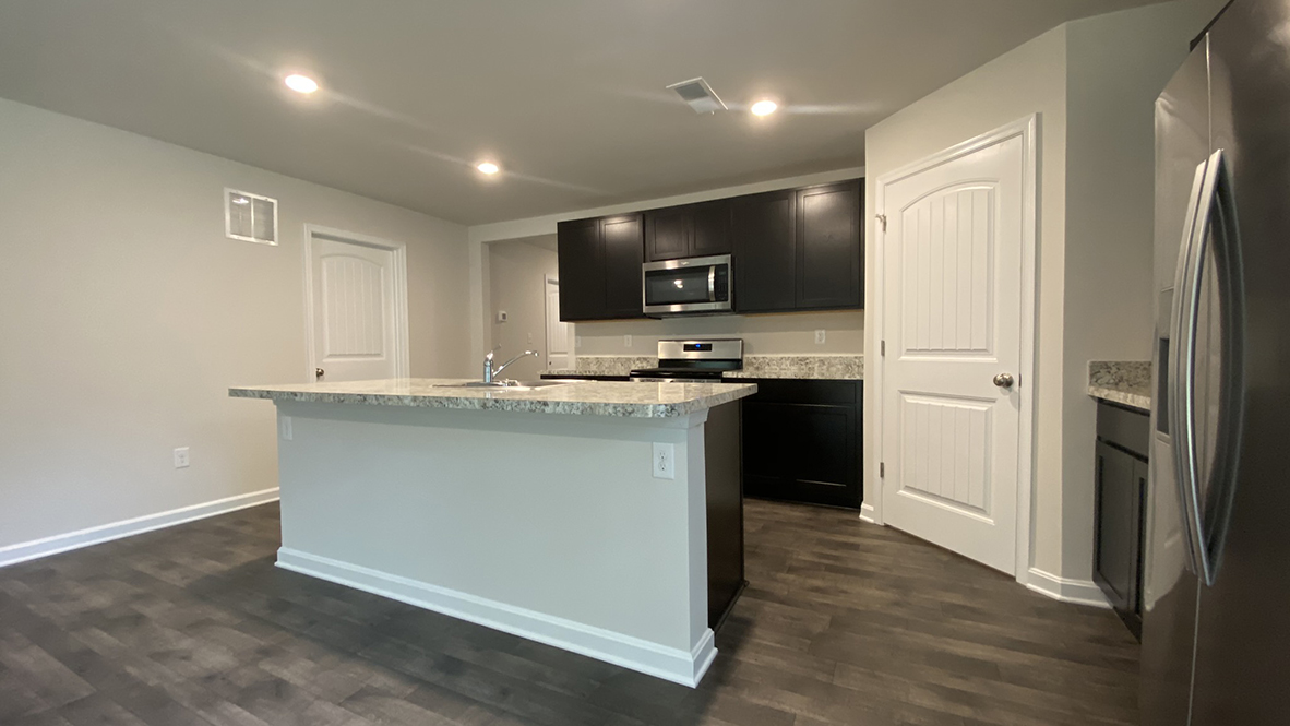 The home's well-designed kitchen features granite countertops.