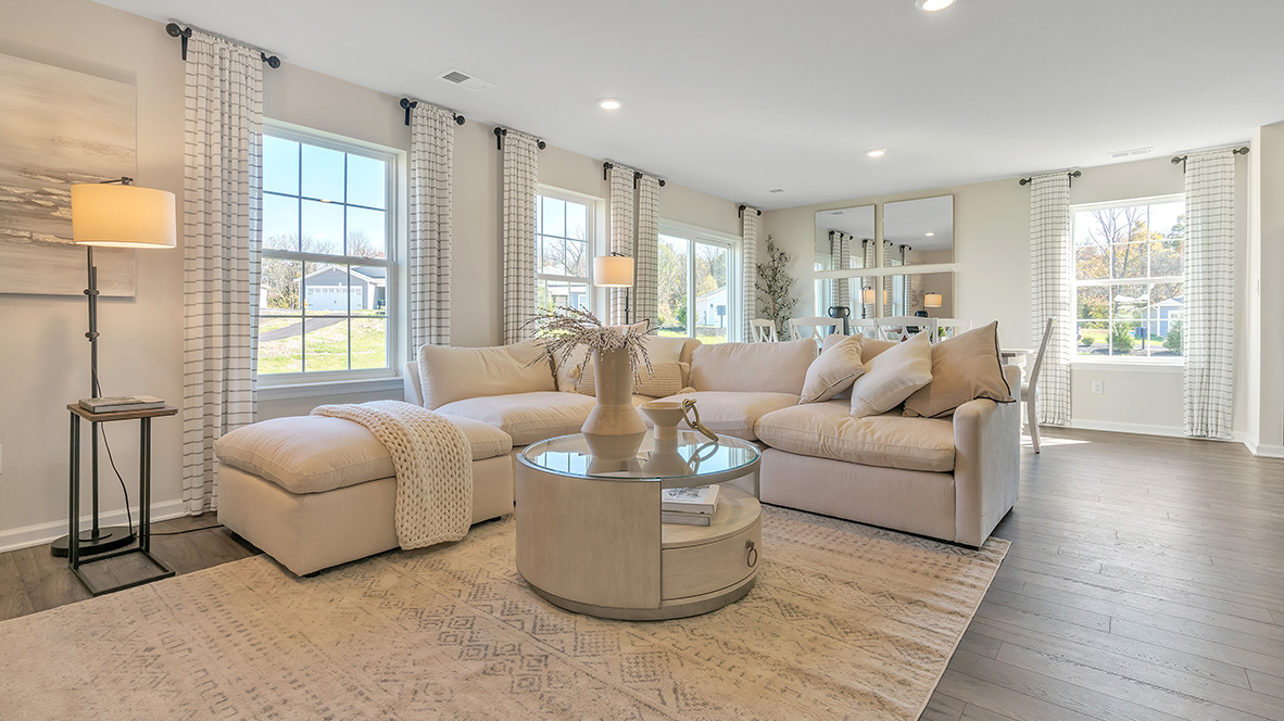 The ample great room and dining area both offer an abundance of natural light.