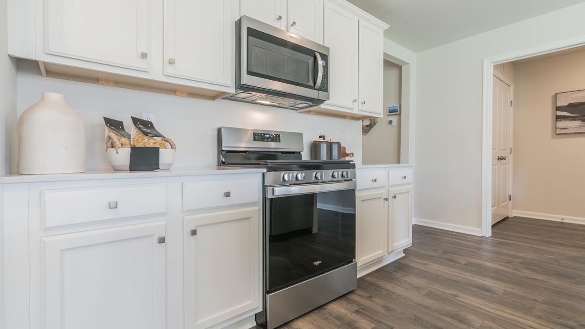 The home's well-designed kitchen features tasteful cabinetry.