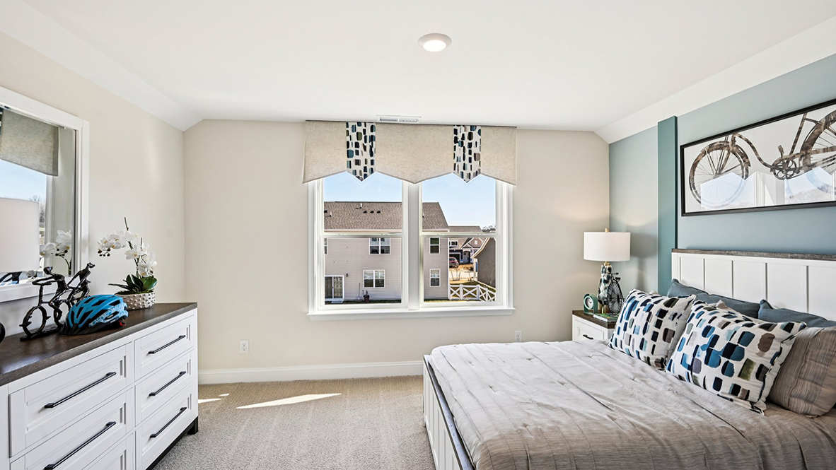 The spacious guest bedroom has a closet.