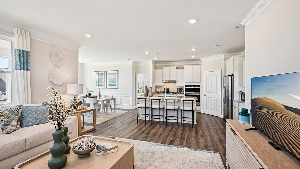 The living area opens into the kitchen and dining rooms.