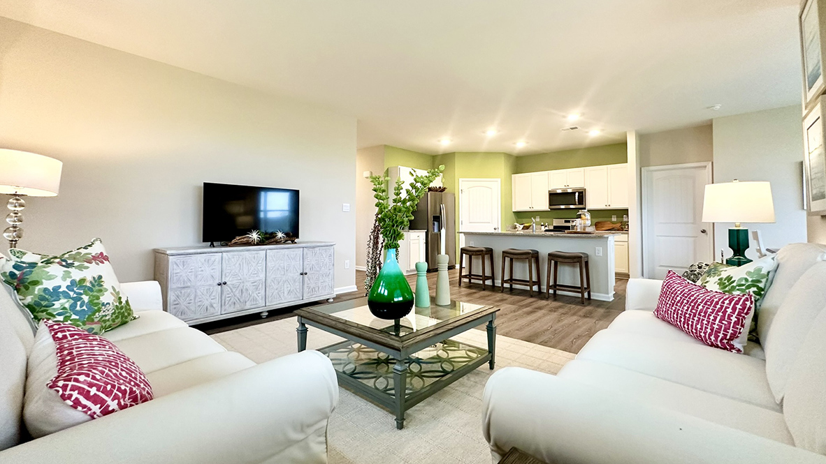 The living area opens into the kitchen and dining rooms.
