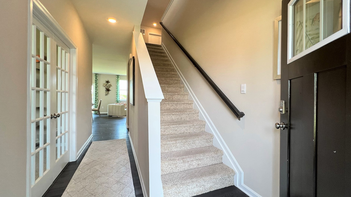 The foyer leads you past the stairway.