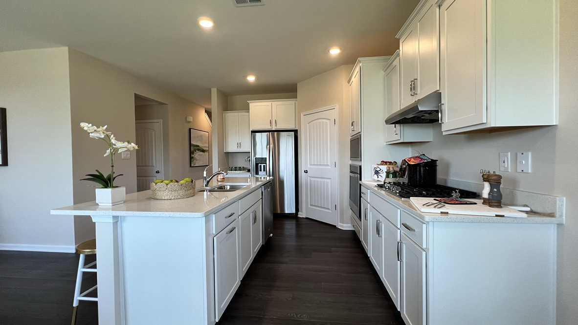 The well-designed kitchen offers modern cabinetry.