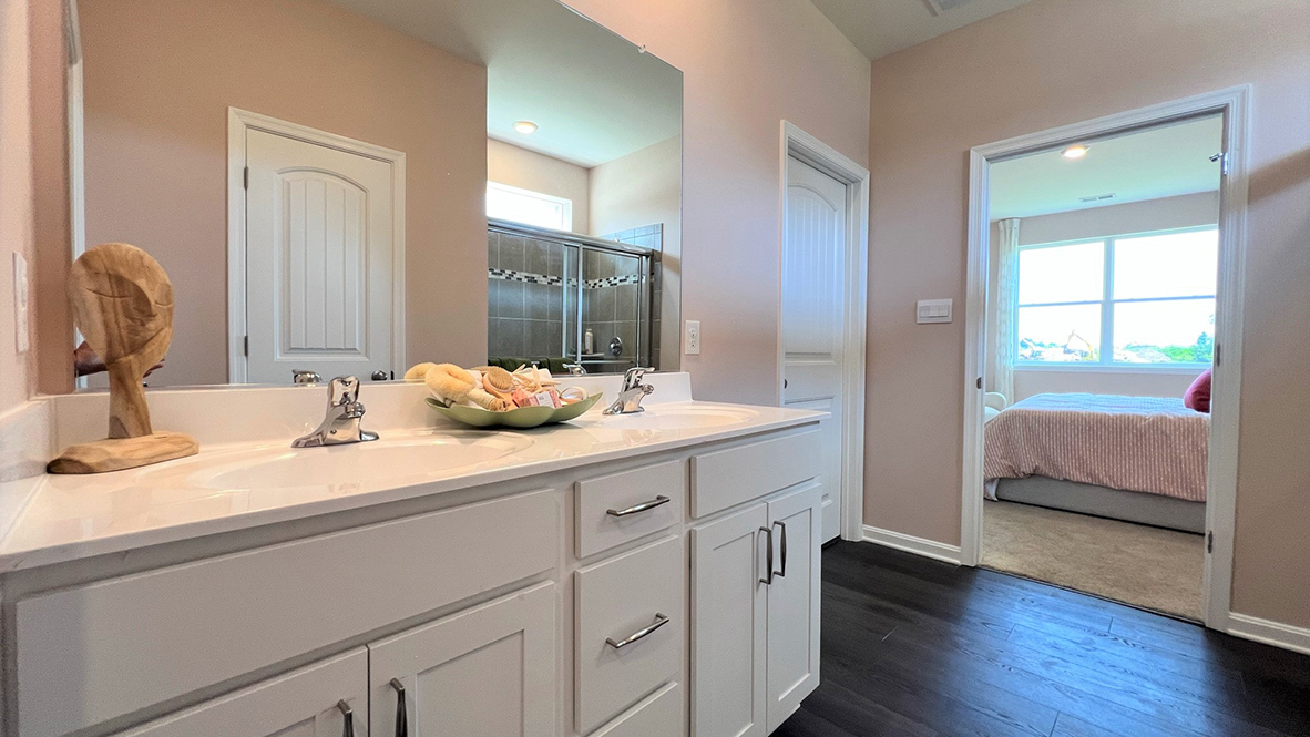 The primary bathroom has a double bowl vanity.