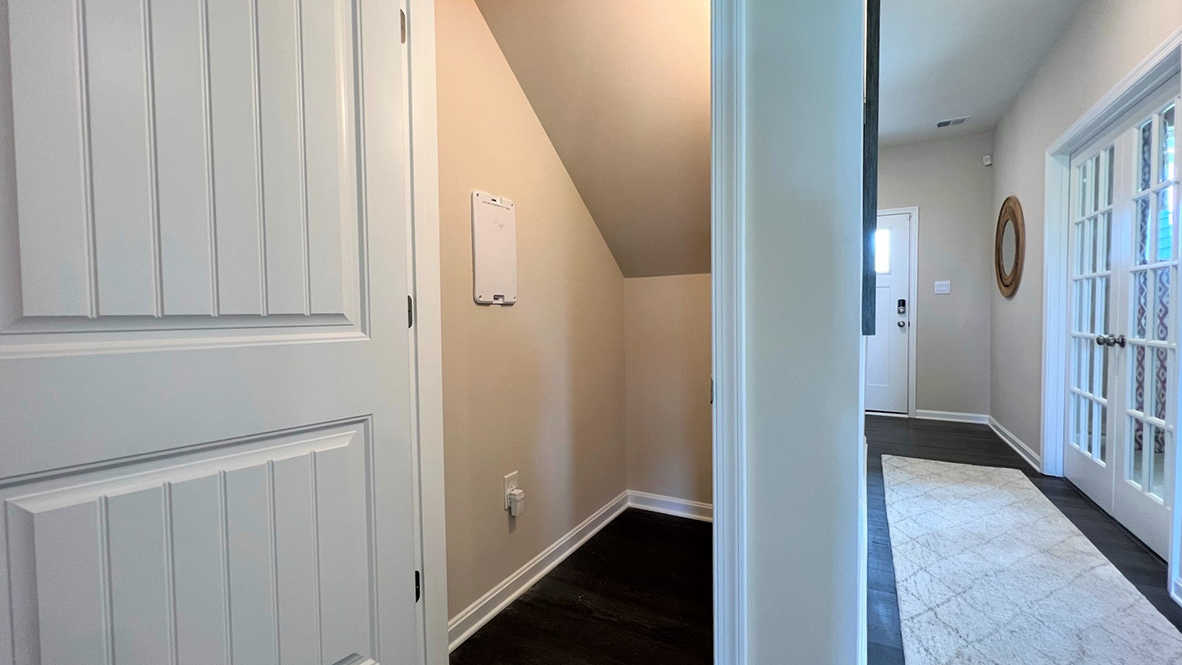 A storage closet is under the stairwell.