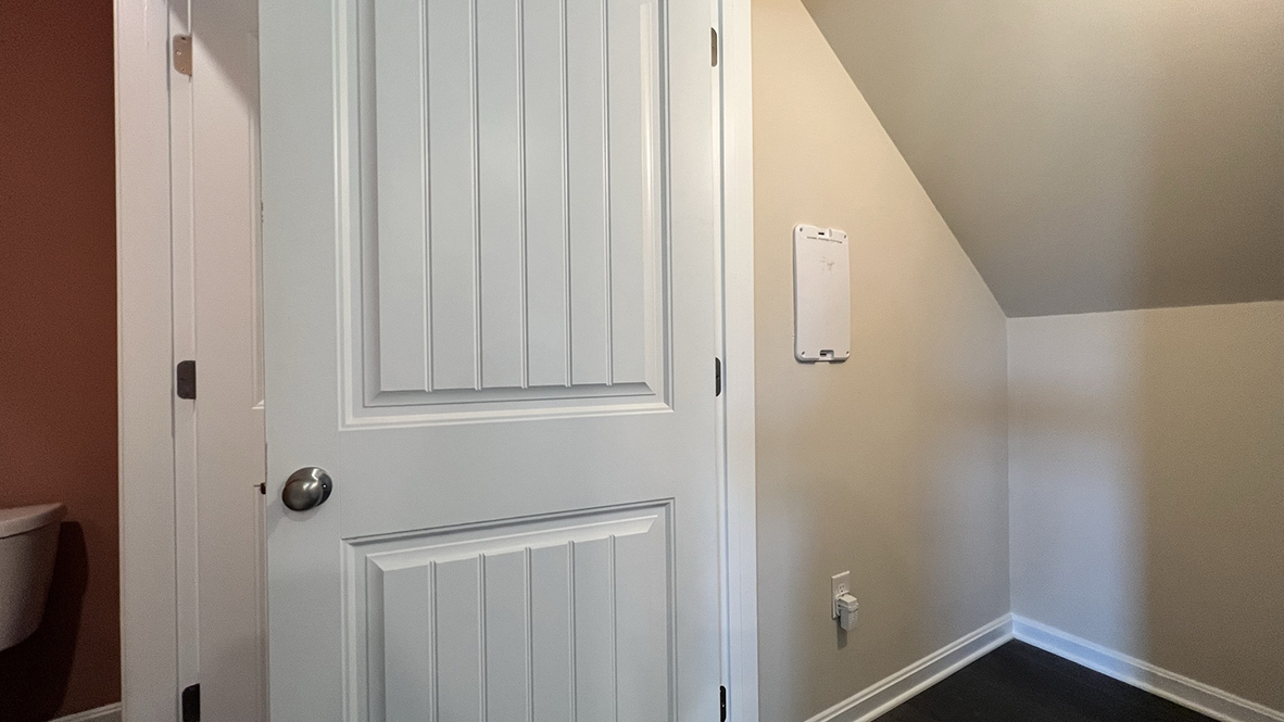 A storage closet is under the stairwell.