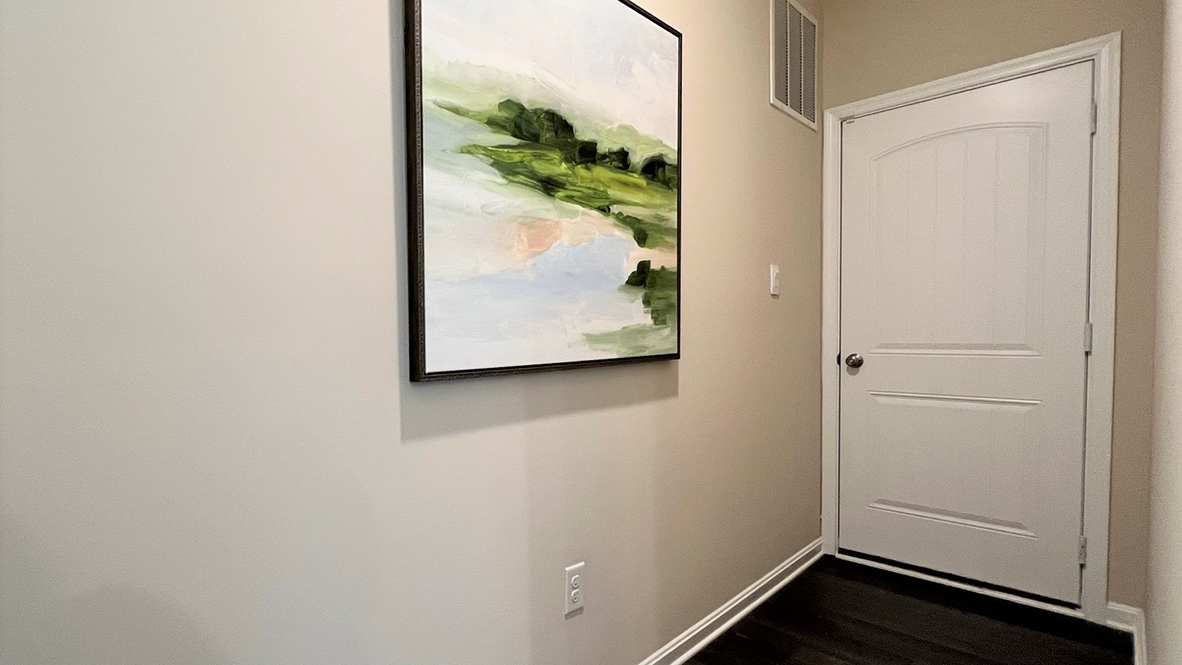 The entrance to the two-car garage is conveniently located near the powder room.