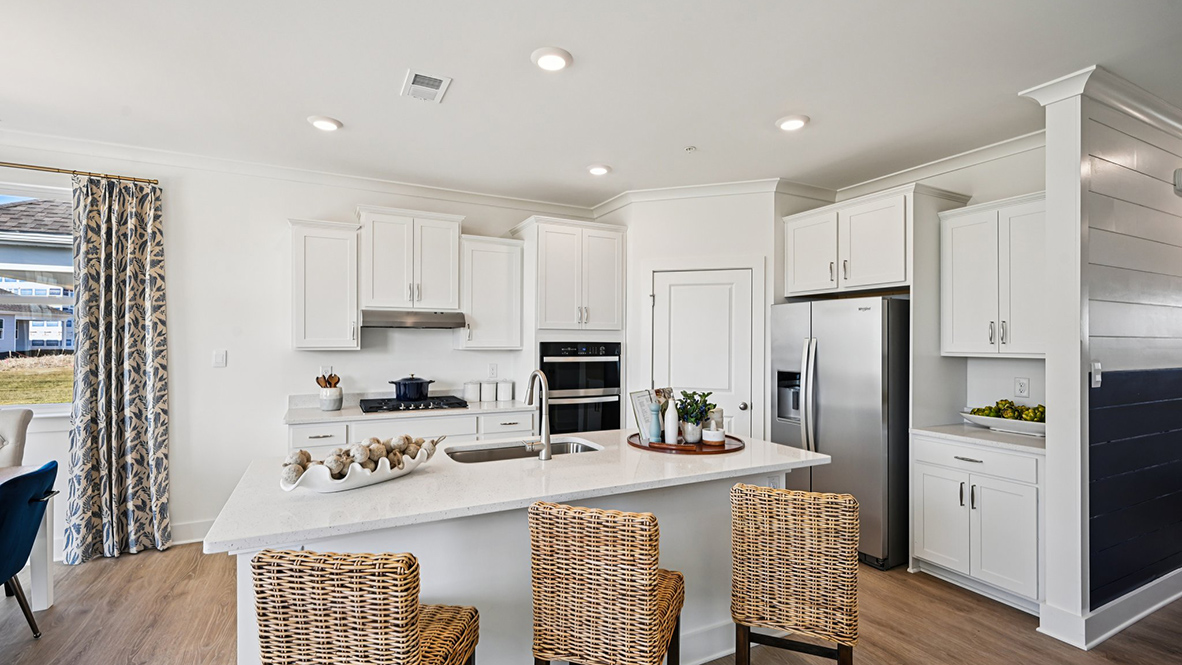 The kitchen includes stainless steel appliances.
