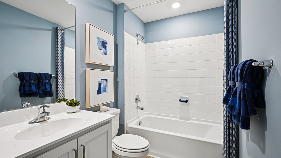 The bathroom has a tub shower.