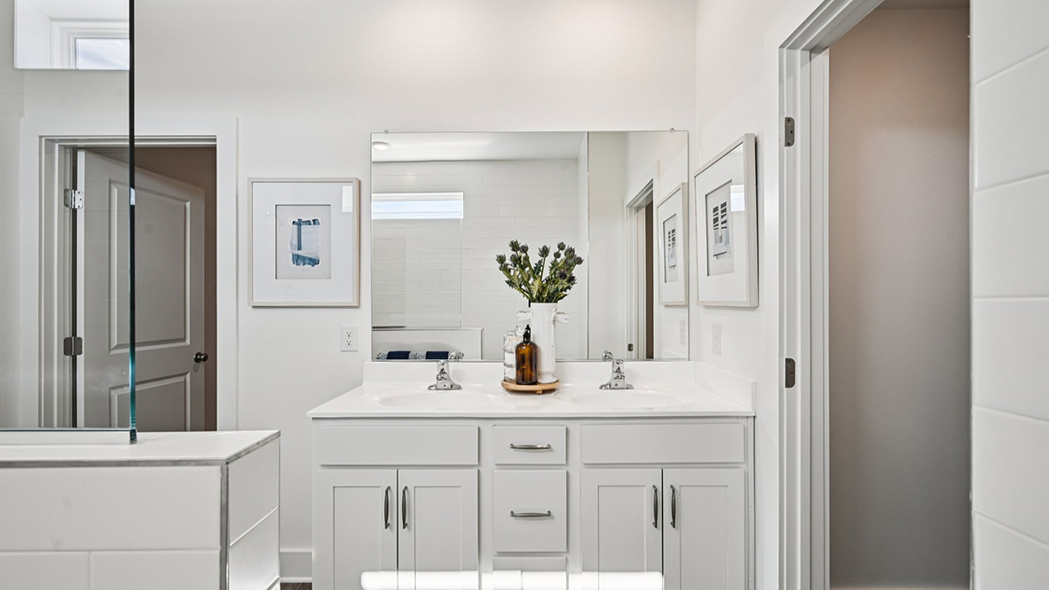 The primary bathroom has a double bowl vanity.