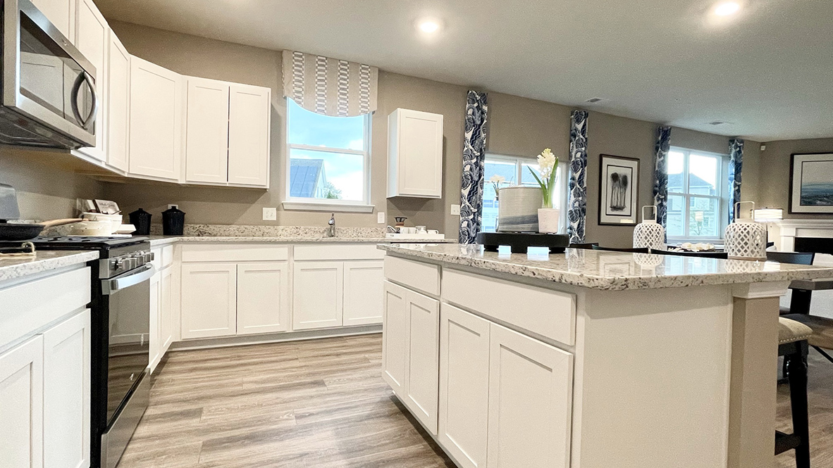 The spacious kitchen boasts granite countertops.