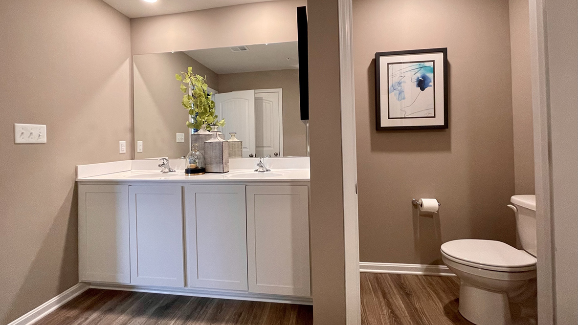 The oversized owner’s bathroom has a double-bowl vanity with a linen closet.