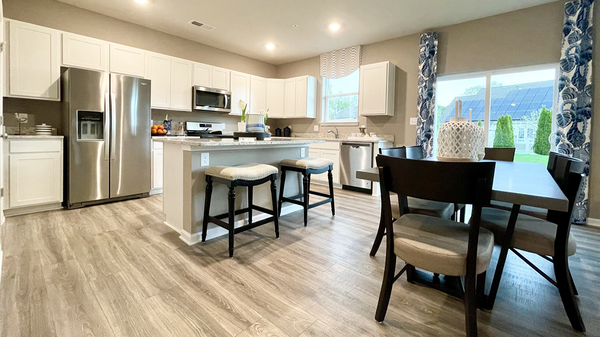 The open-concept kitchen leads into the dining area.