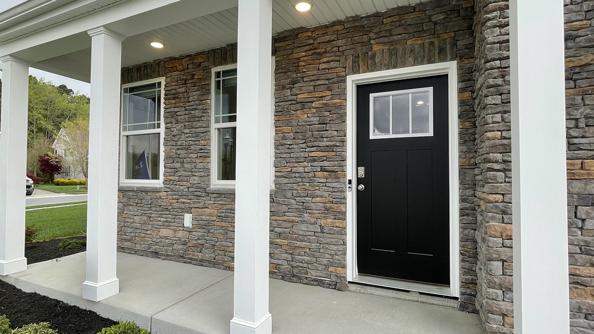 This contemporary two-story home features a full front porch.