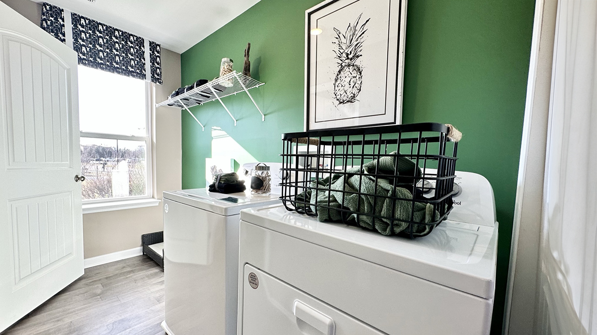 The laundry room is conveniently located off the kitchen on the first floor.
