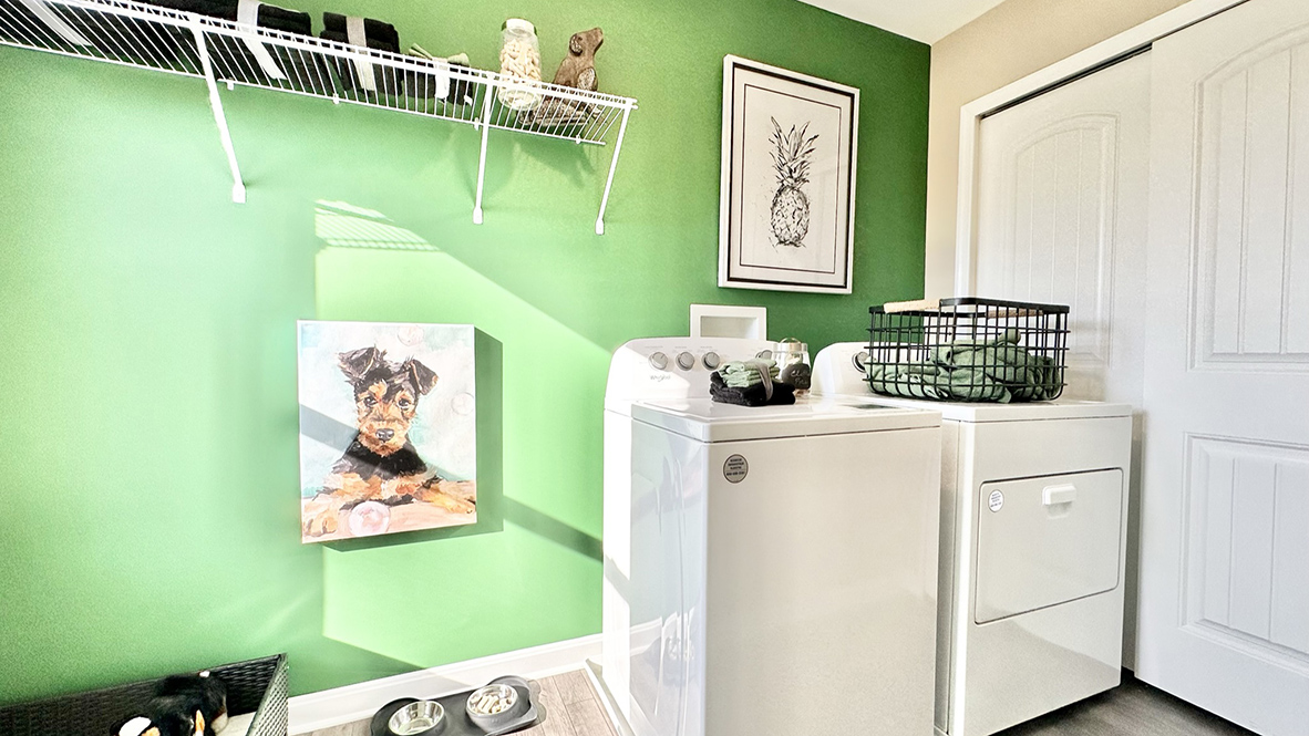 The laundry room is conveniently located off the kitchen on the first floor.