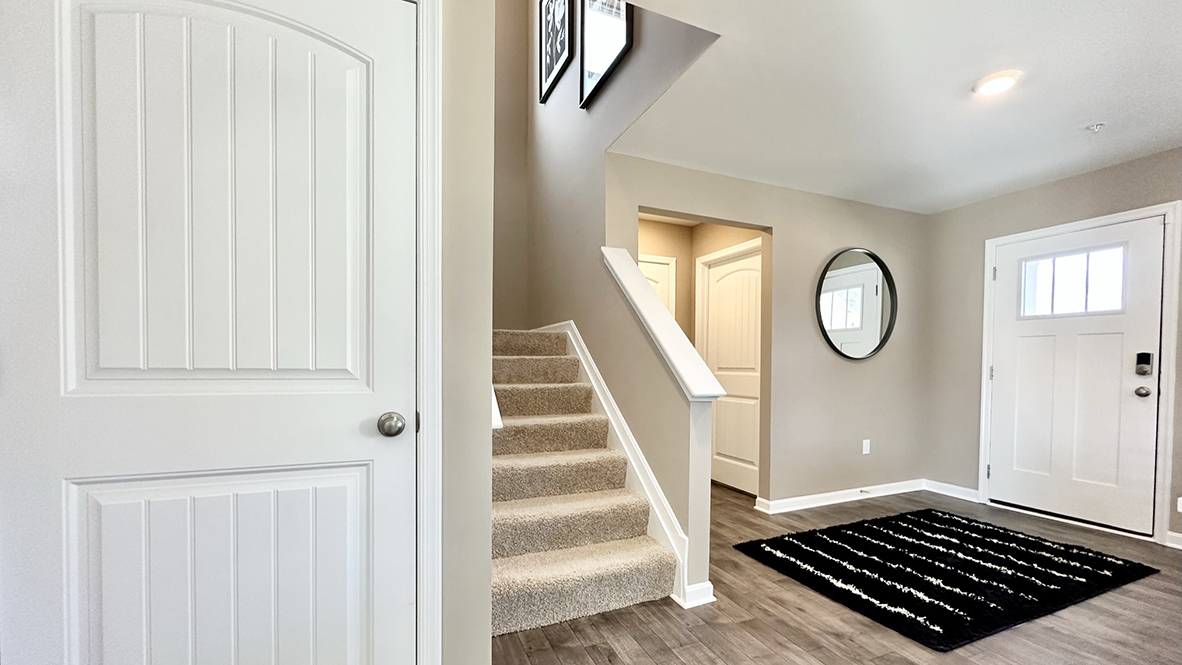 A coat closet is located next to the stairs.