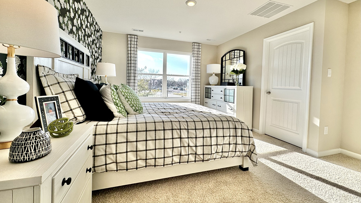 The upstairs owner's bedroom with an en suite bathroom and a walk-in closet sits in the back of the home for privacy.