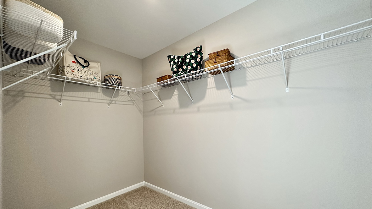 The upstairs owner's bedroom with an en suite bathroom and a walk-in closet sits in the back of the home for privacy.