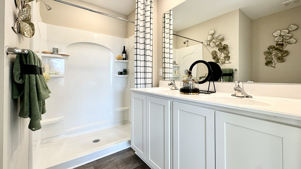 The upstairs owner's bedroom with an en suite bathroom and a walk-in closet sits in the back of the home for privacy.