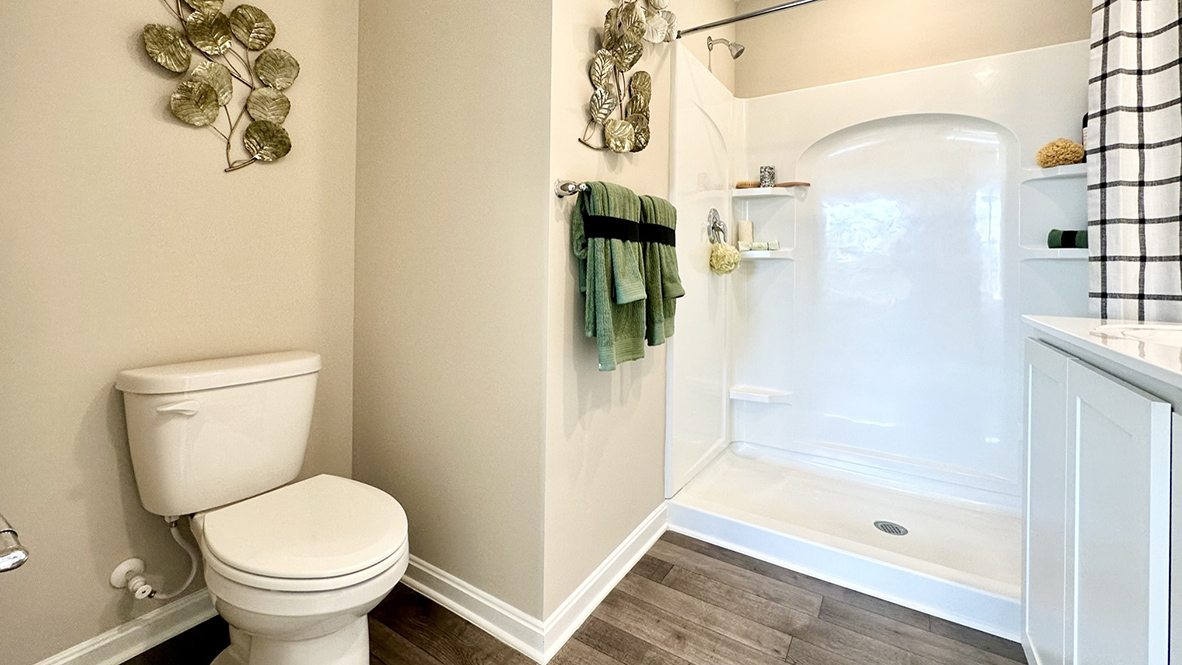The upstairs owner's bedroom with an en suite bathroom and a walk-in closet sits in the back of the home for privacy.