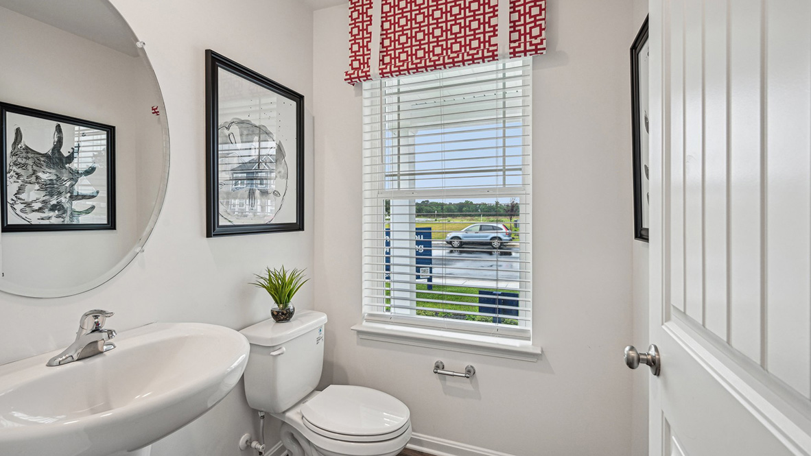 A powder room is conveniently located on the first floor tucked away in a private nook.