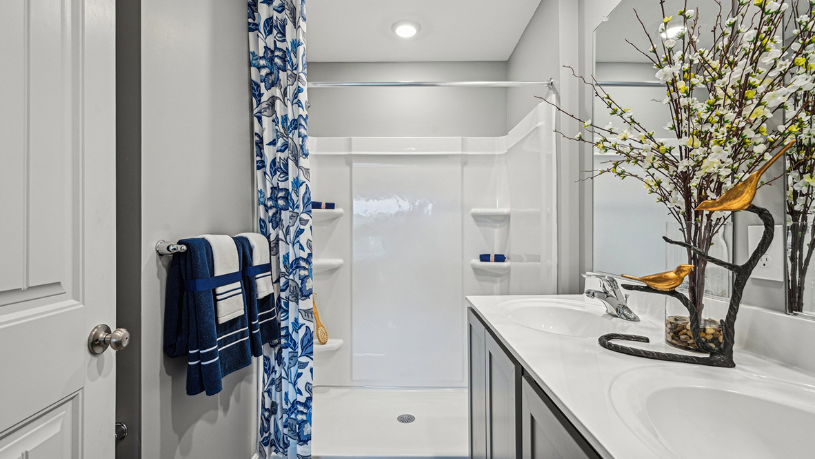 The upstairs owner's bedroom with an en suite bathroom and a walk-in closet sits in the back of the home for privacy.
