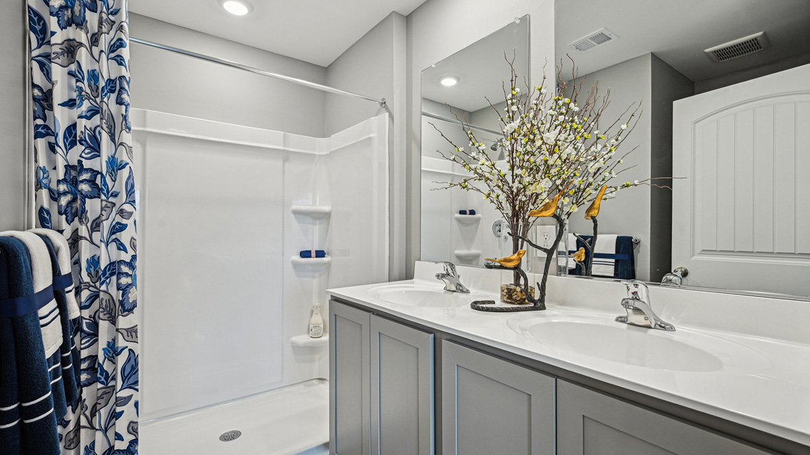 The upstairs owner's bedroom with an en suite bathroom and a walk-in closet sits in the back of the home for privacy.