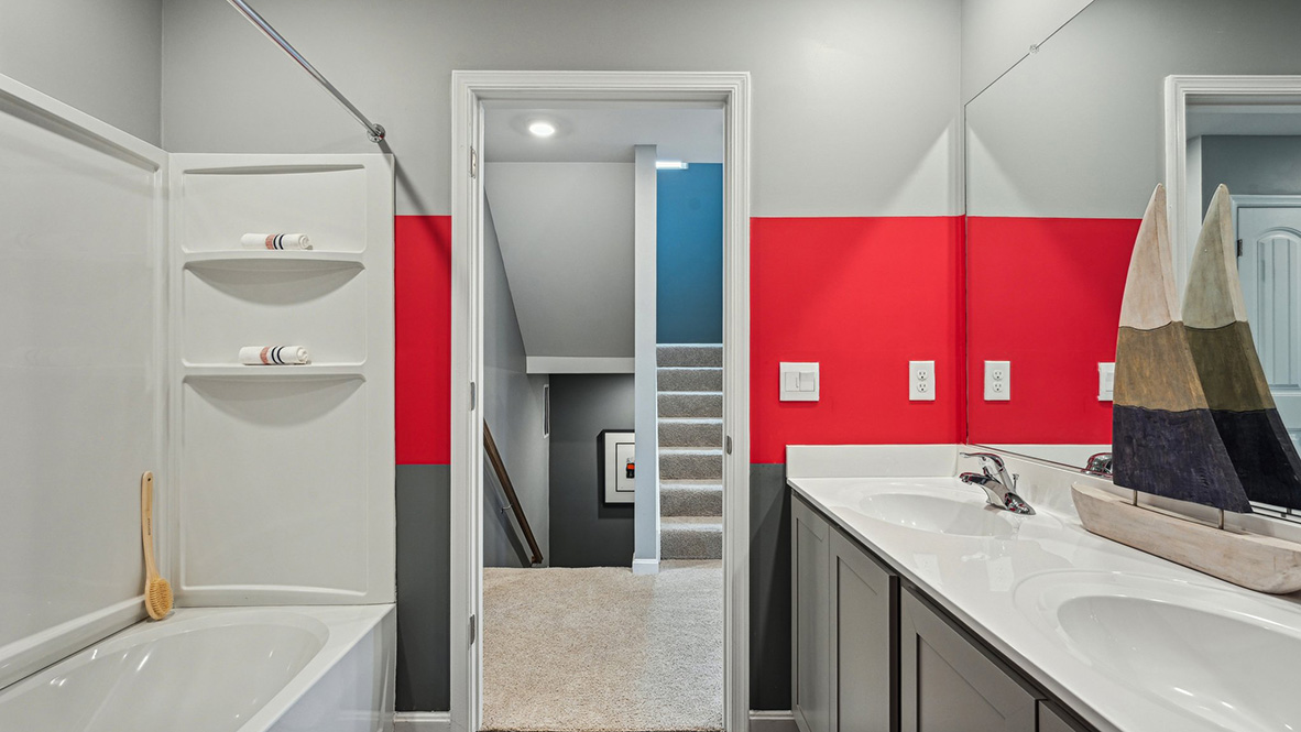 The third floor offers the fifth bedroom and a third full bathroom.