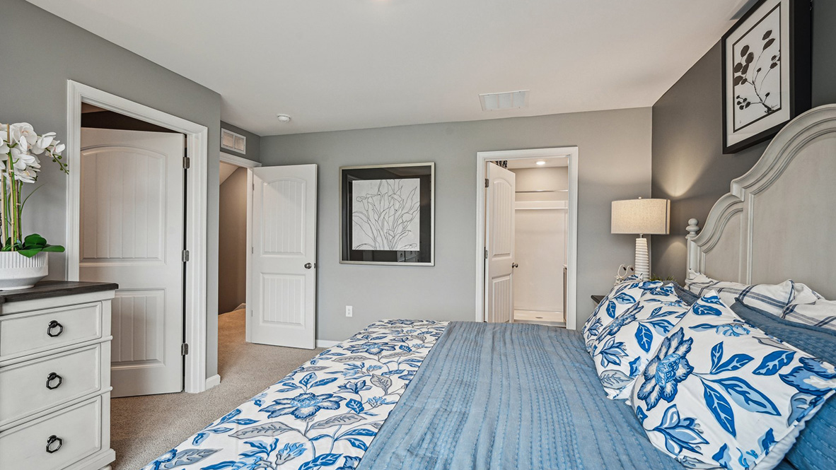 The upstairs owner's bedroom with an en suite bathroom and a walk-in closet sits in the back of the home for privacy.