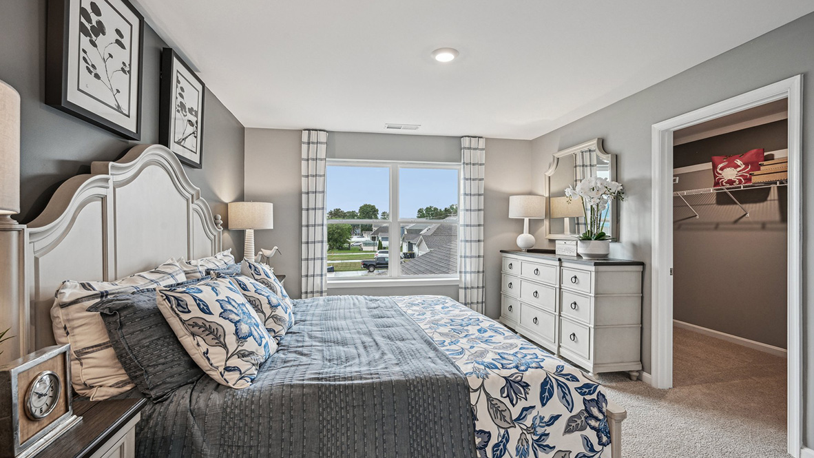 The upstairs owner's bedroom with an en suite bathroom and a walk-in closet sits in the back of the home for privacy.