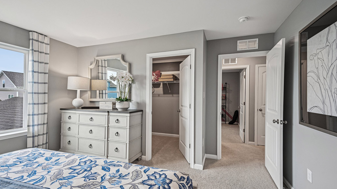 The upstairs owner's bedroom with an en suite bathroom and a walk-in closet sits in the back of the home for privacy.