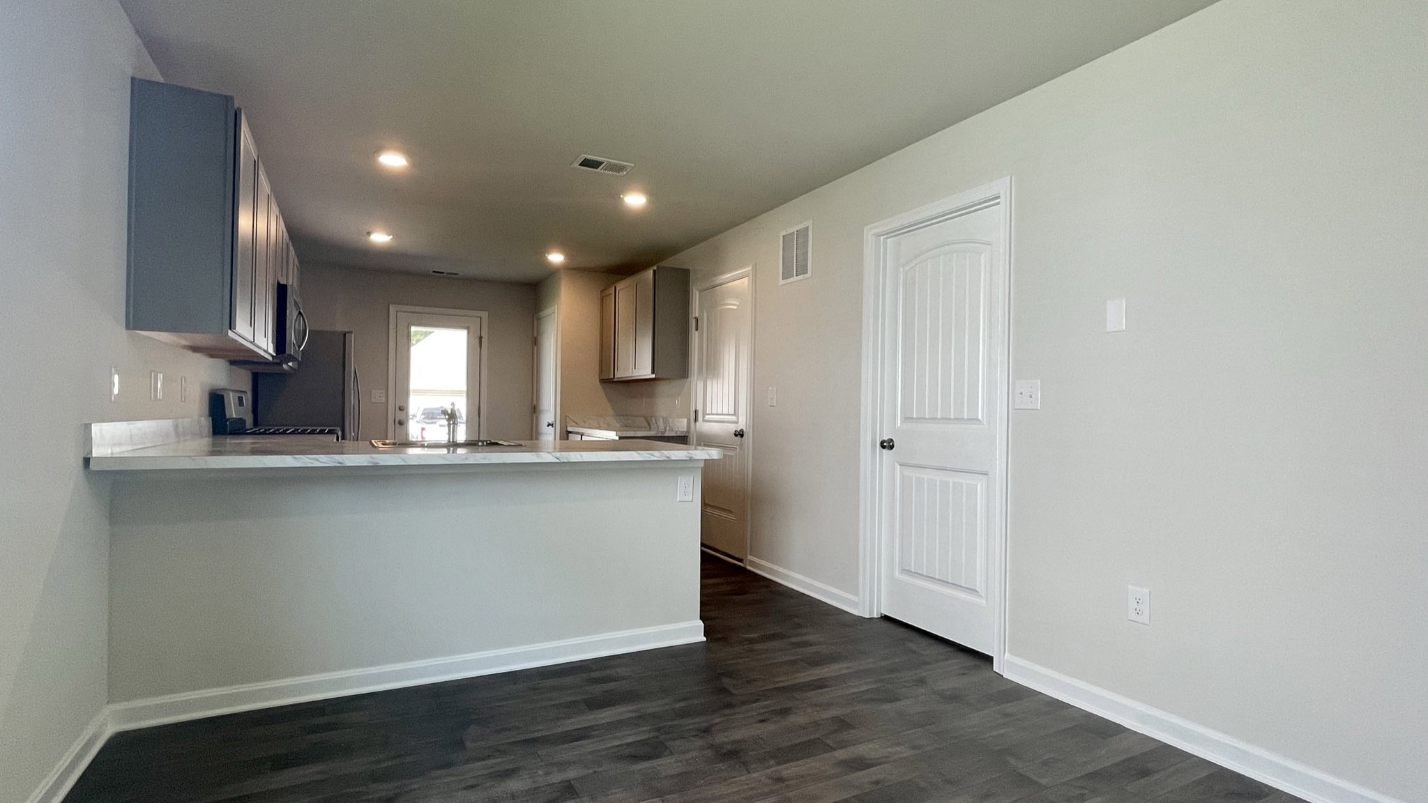 The well-appointed kitchen features a peninsula island with additional room for seating.