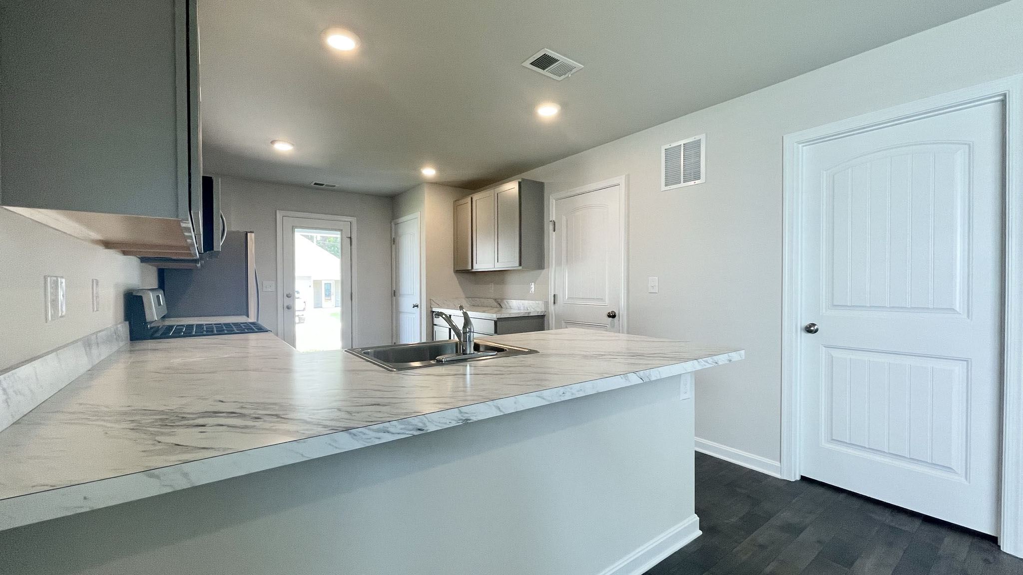 The well-appointed kitchen features a peninsula island with additional room for seating.